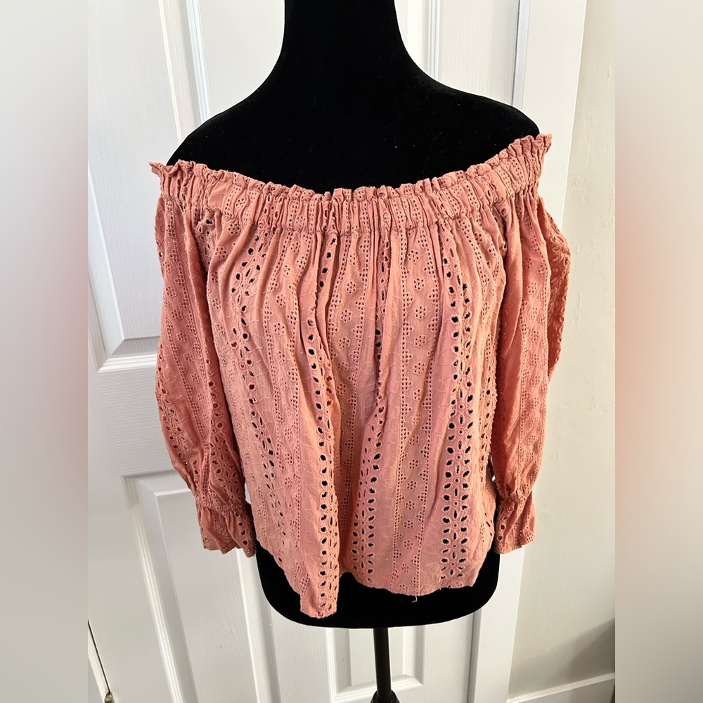 Woman’s eyelet off the shoulder top.